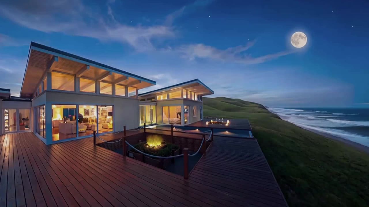 Moonlit lounge and water feature at night with warm architectural uplighting, Hawke's Bay luxury coastal home interior