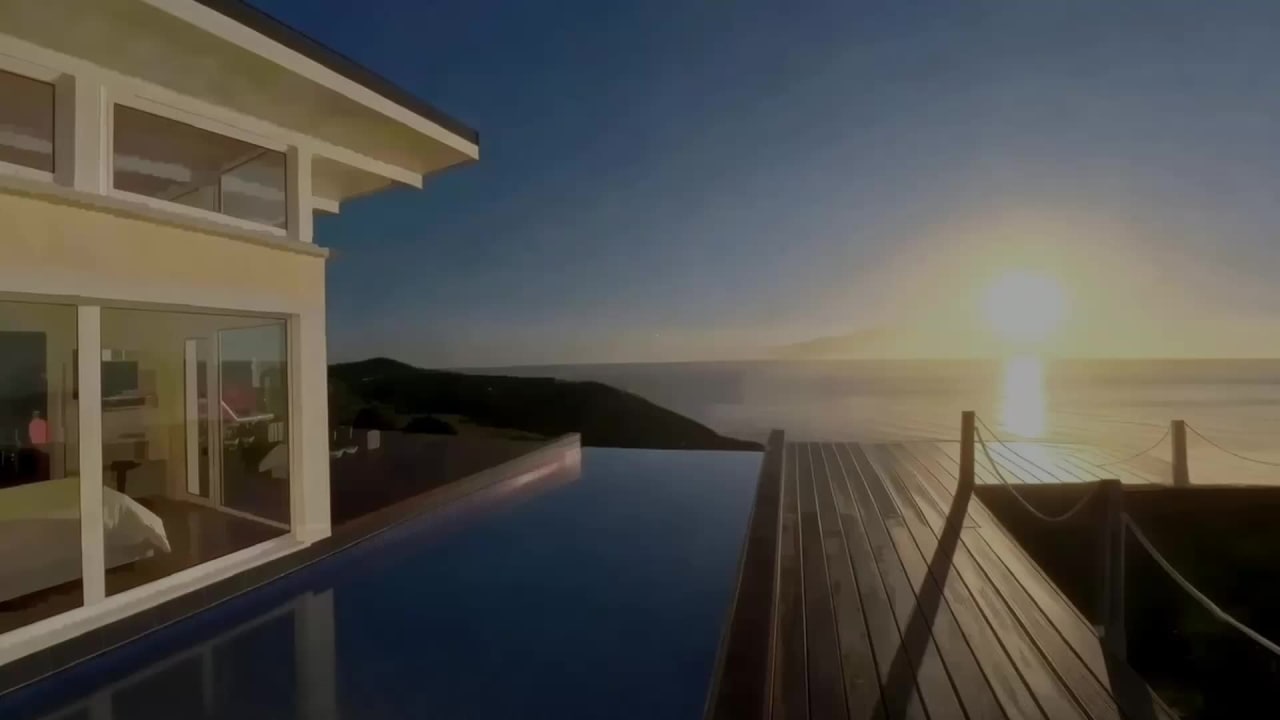Seaview bedroom and infinity water feature at sunrise, viewed from the glass link corridor, Bay House Hawke's Bay