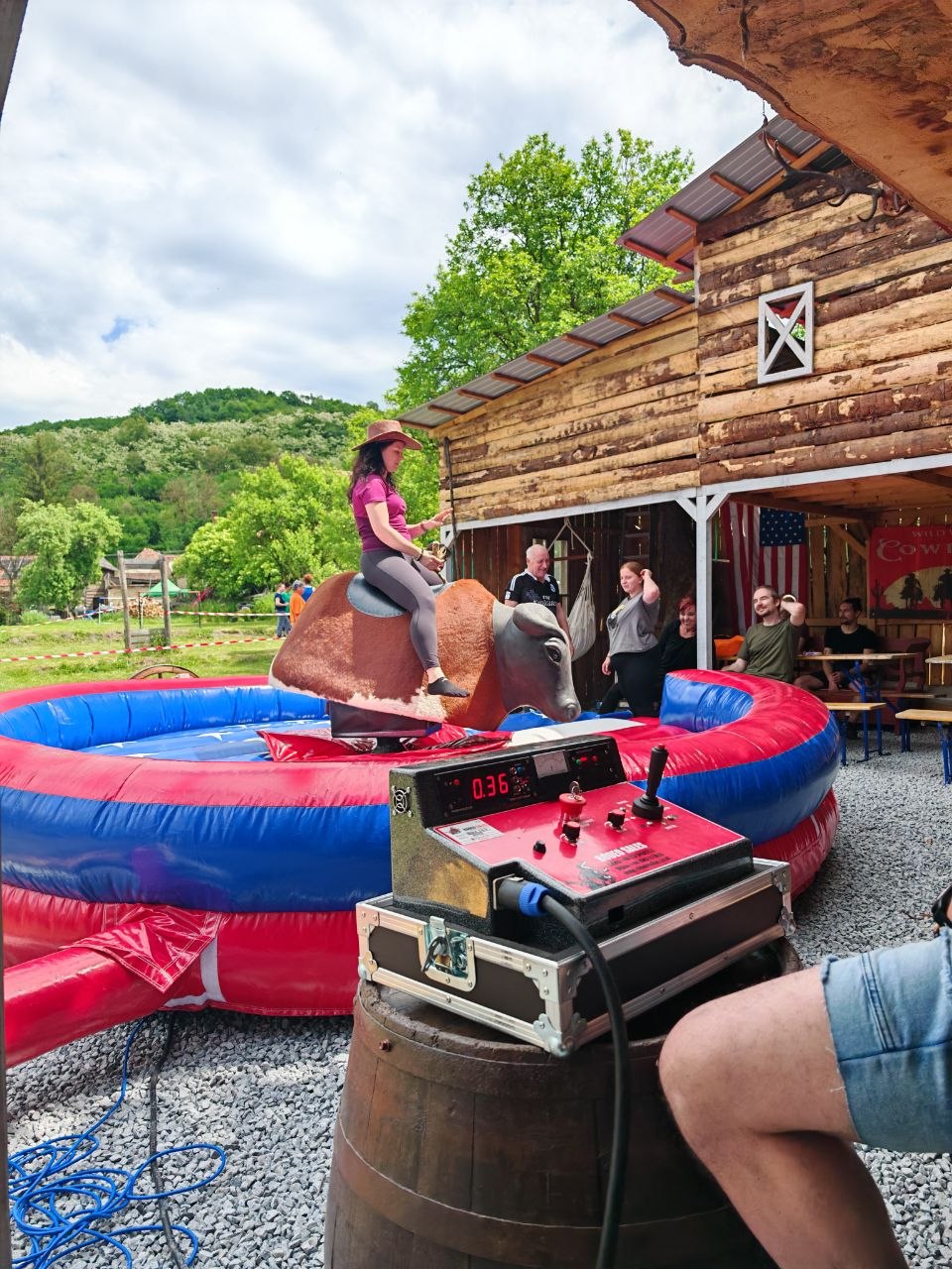 A guest riding the mechanical bull during the Viessmann Transilvania company sports day at Two Boots Ranch