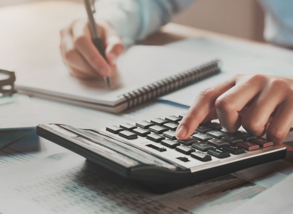 Financial planning with calculator and notepad
