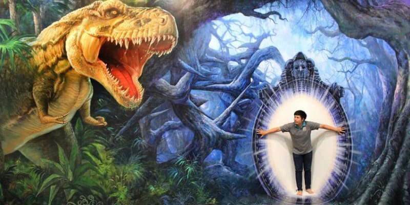A Man Stands Amidst T-Rex Eggs In A Nest, Attentively Observing The Lifelike T-Rex Family.