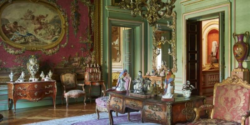 An Opulent Room At Laria Palace Displaying Regal Furnishings, Intricate Paintings, And Elegant Sculptures.