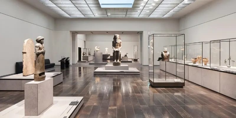  A Room Full Of Exhibits That Span Across Different Civilizations And Time Periods With An Array Of Sculptures, Paintings, Textiles, And Contemporary Art.