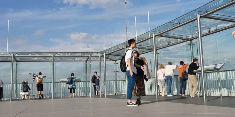 Visitors Observe Paris Through The Glass Walls Atop The Montparnasse Skyscraper.