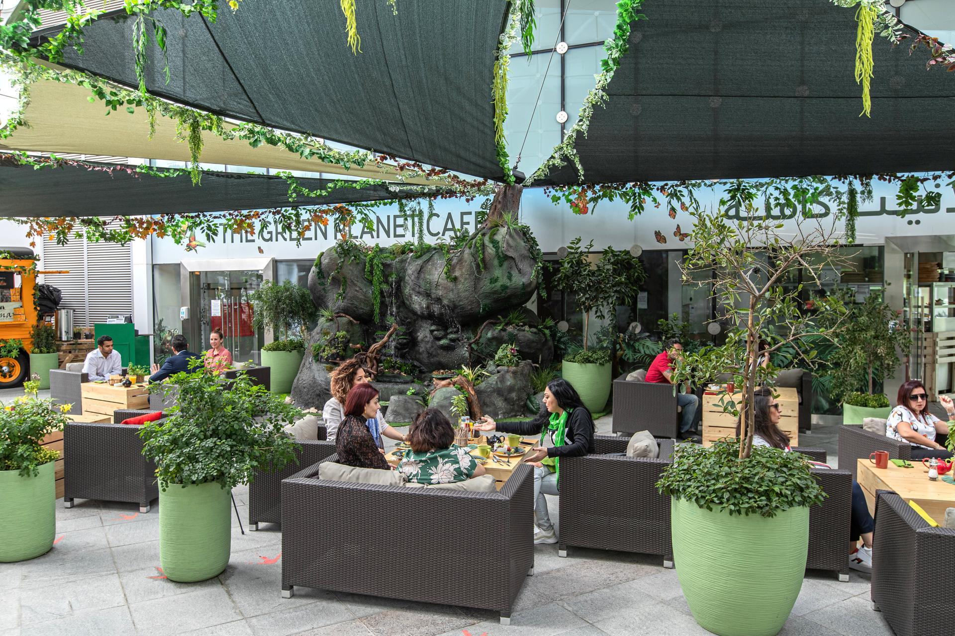 People chilling in the lush Green Planet Cafe