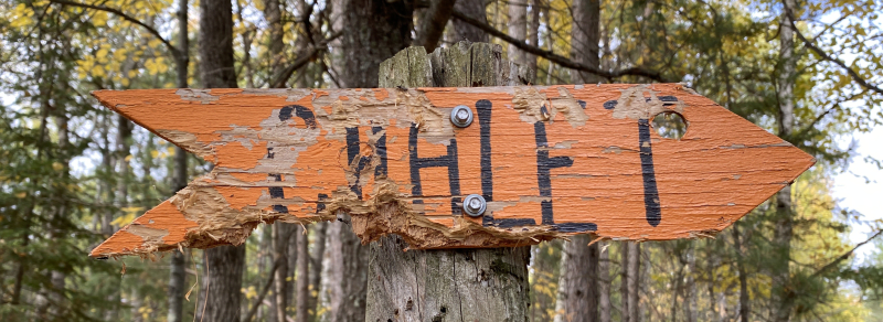 A weathered sign directs visitors to the chalet.