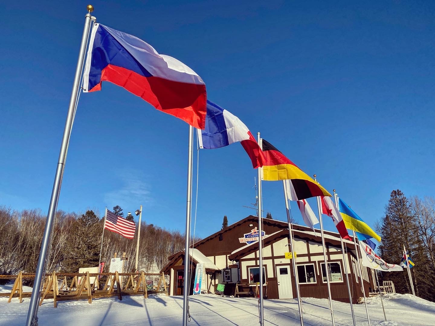 A few of our flags flying high in front of the chalet