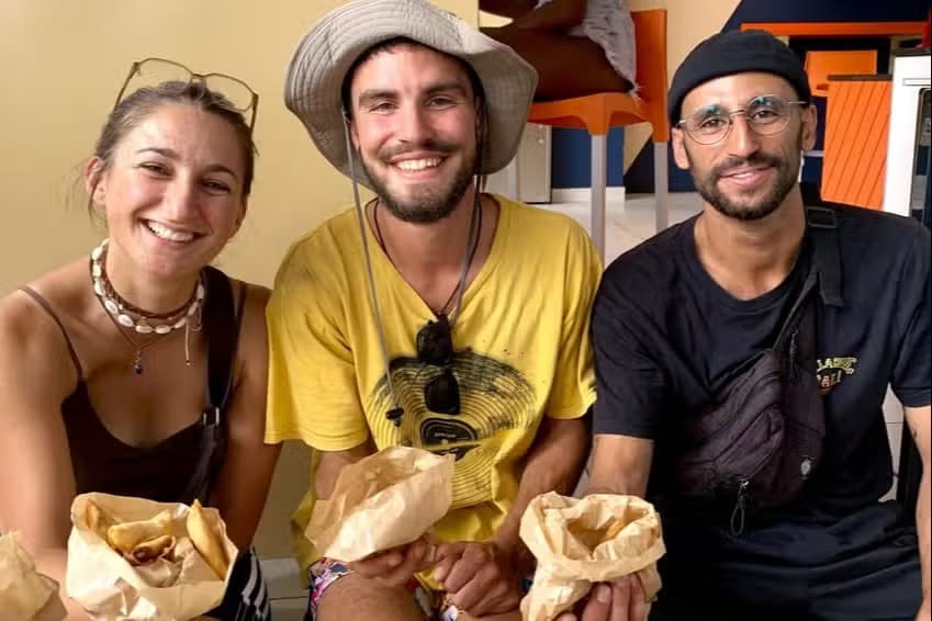 Participants tasting wrapped Creole specialities during a guided food tour in Saint-Denis, Reunion Island