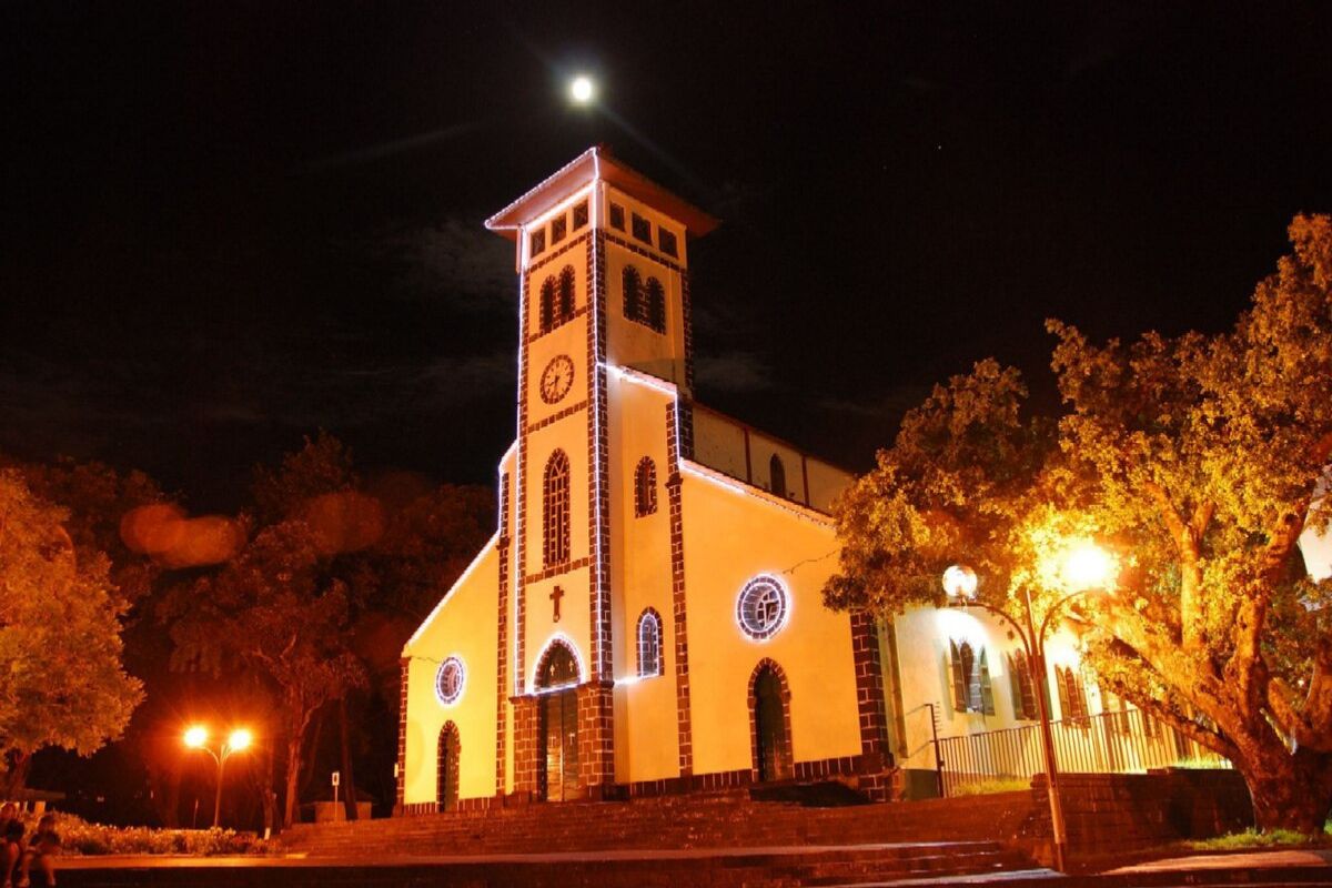 An illuminated church in Le Tampon, Reunion Island, at night under a full moon