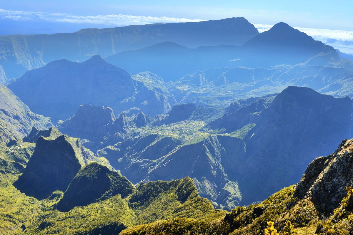 Panoramic view from Le Maïdo over the Mafate cirque in Reunion Island, jagged peaks, tropical forest and a sea of clouds