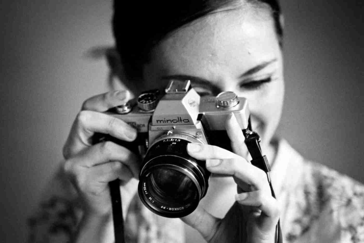 photographer with Minolta 35mm film SLR camera