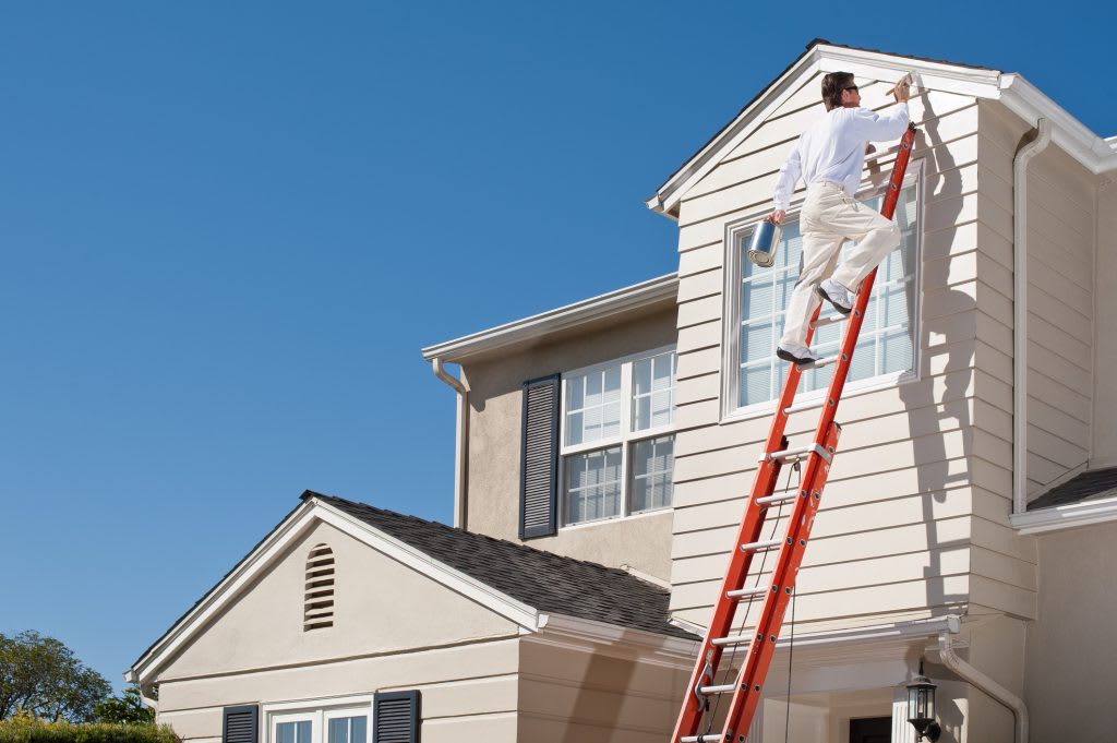 Exterior house painter on a ladder