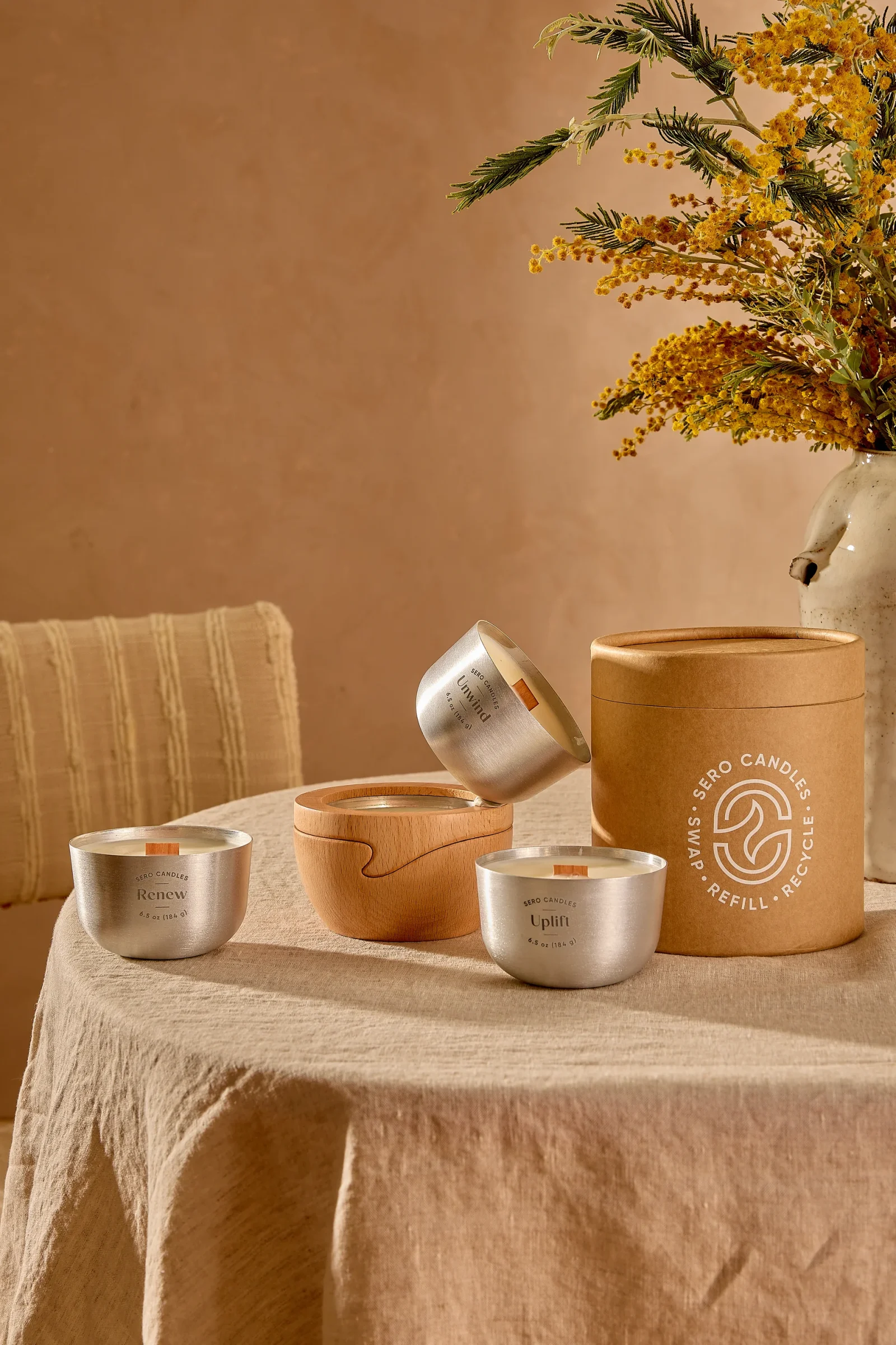 Sero's three scent profiles, Renew, Unwind, and Uplift, beside a beech wood container and packaging