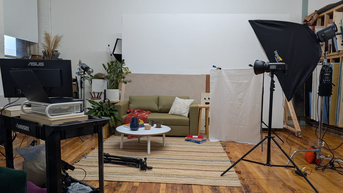 The same studio set with a softbox raised over it and a tethering cart in the foreground