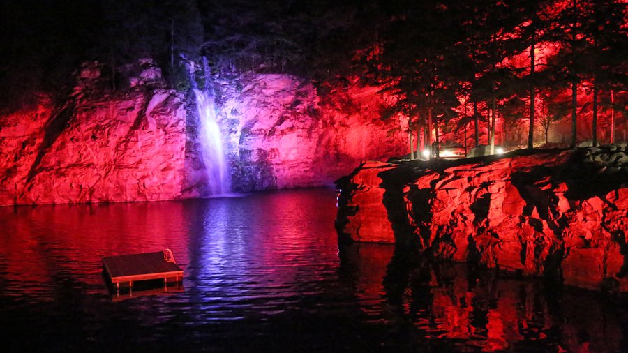The quarry and waterfall illuminated at night at Scarrigan Farms in Mooresville, North Carolina