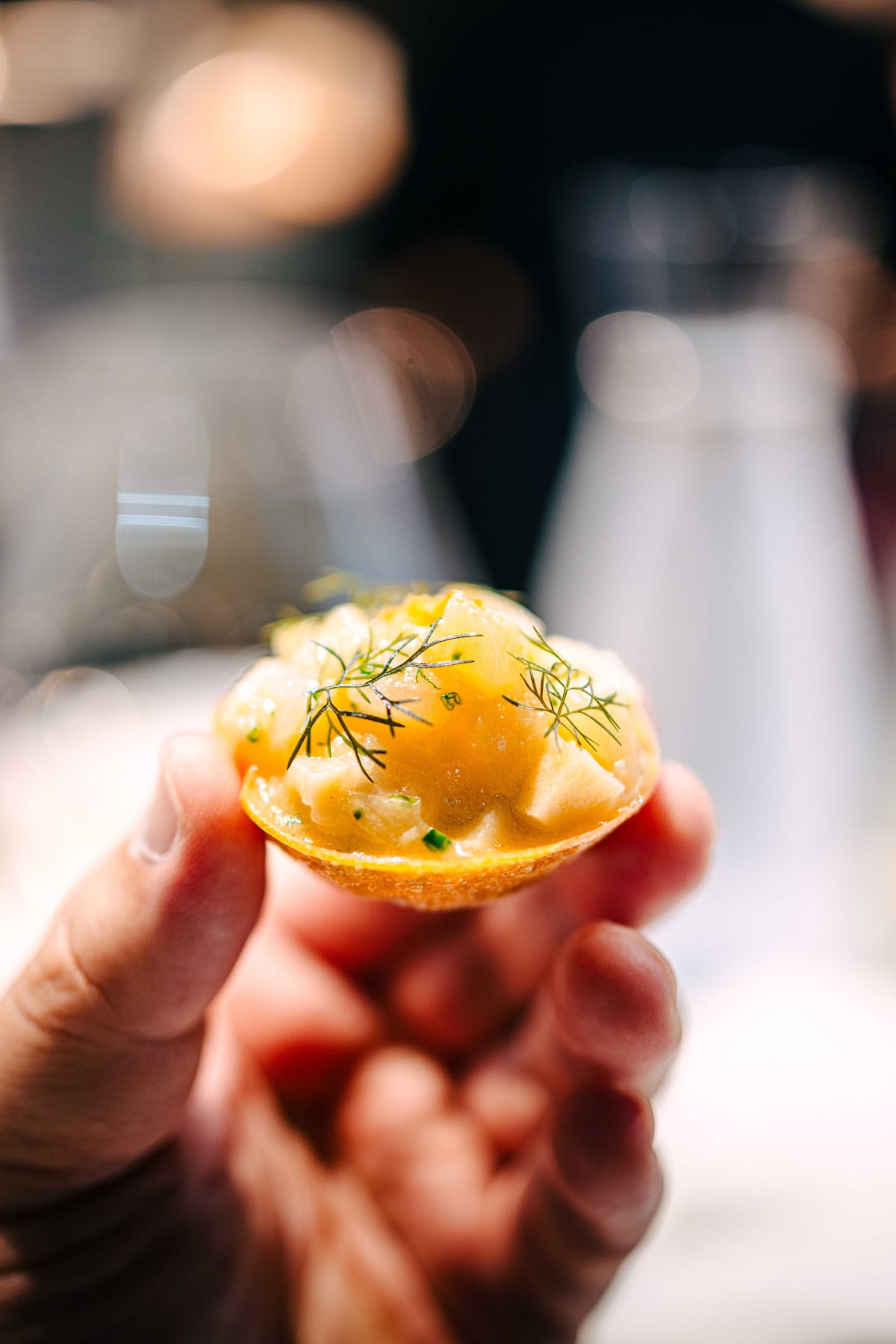 Bistronomy Notre, Seoul: the scallop and bamboo shoot bite held to the light