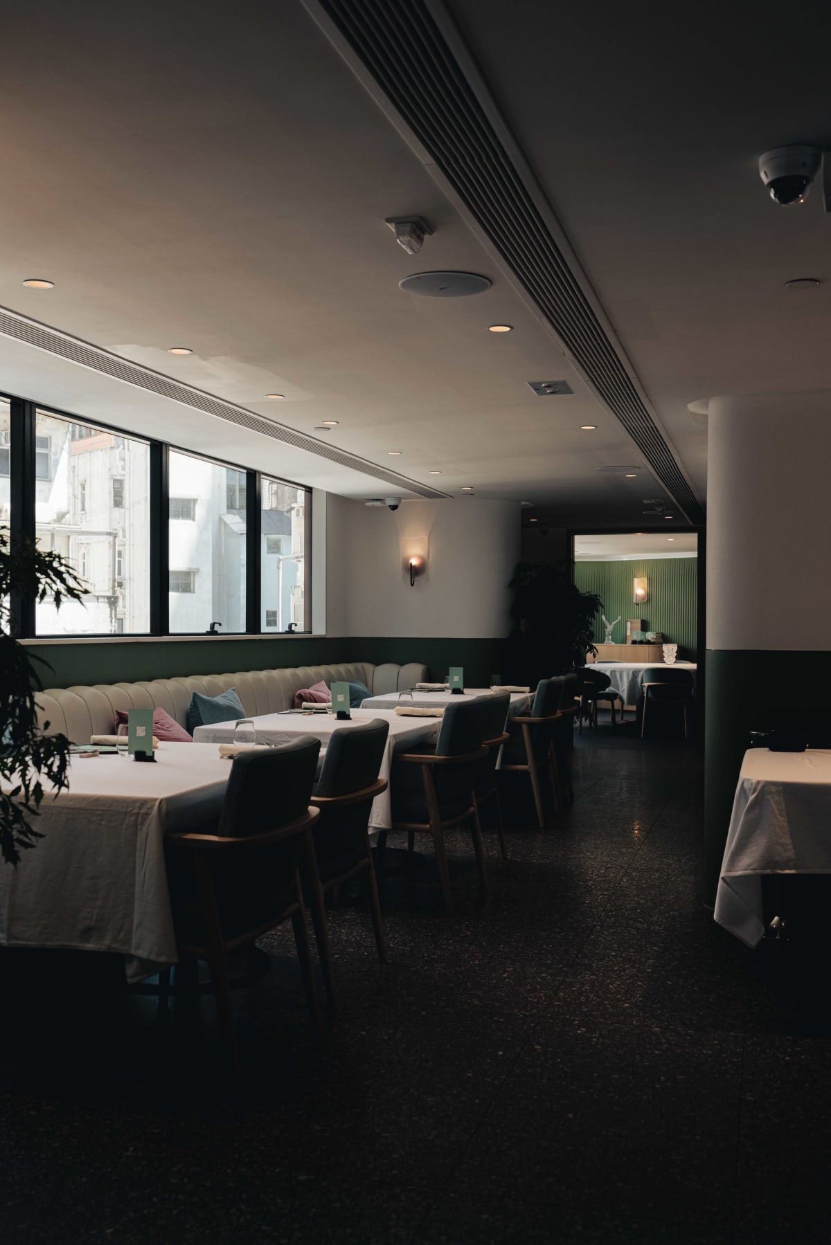 JEE, Hong Kong: the dining room, with windows down one side and a long cream banquette