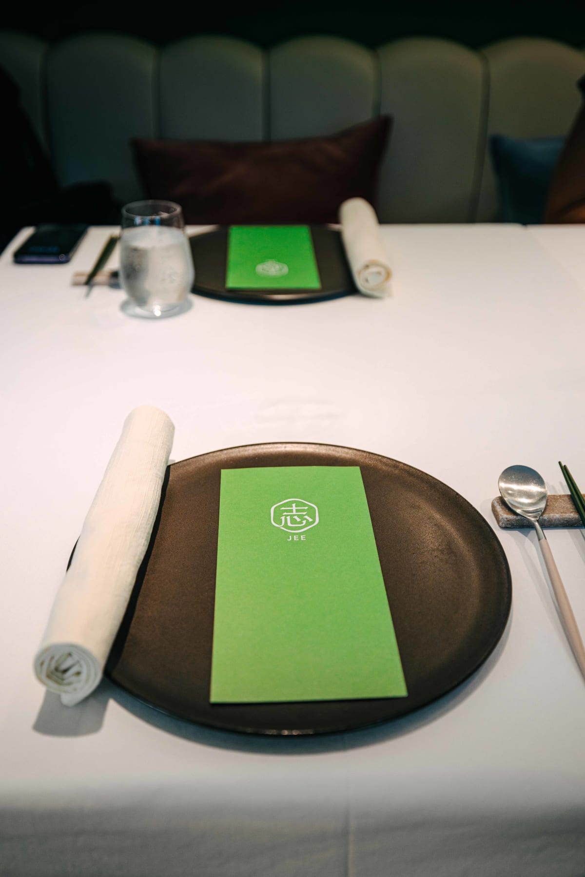 JEE, Hong Kong: the table set for lunch, with the green menu card on the plate