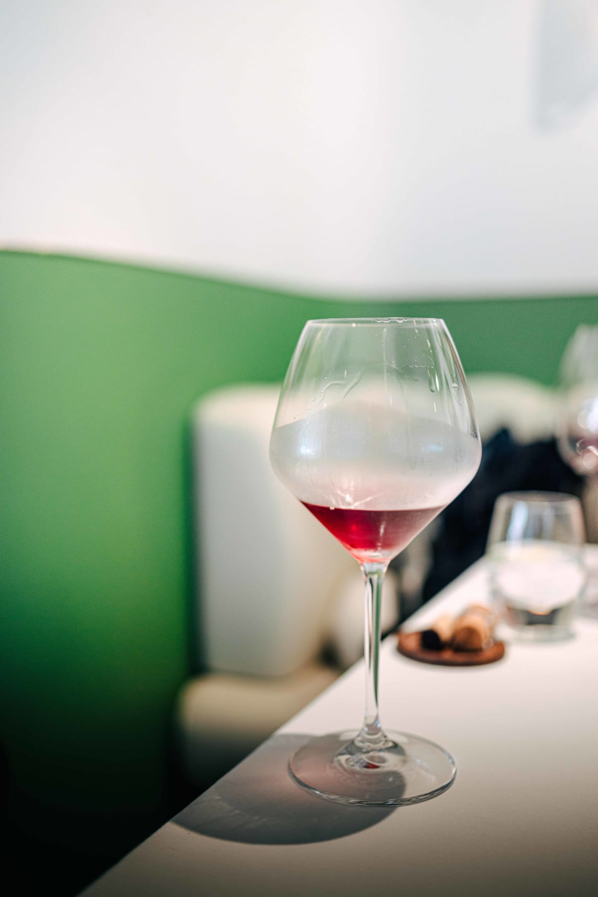 JEE, Hong Kong: the blind glass of red, pale in a chilled Burgundy glass