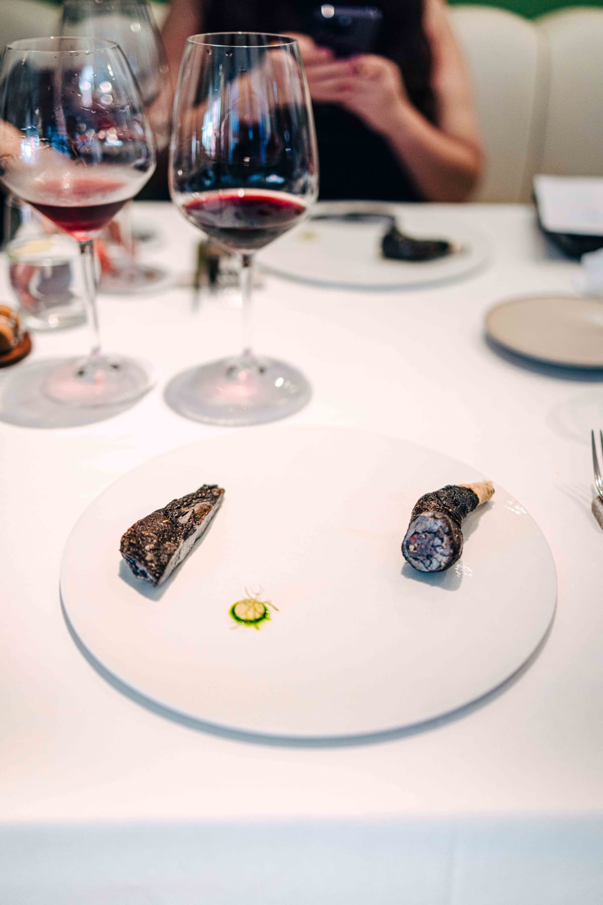 JEE, Hong Kong: the silkie chicken main, breast and stuffed leg, with two glasses of red behind
