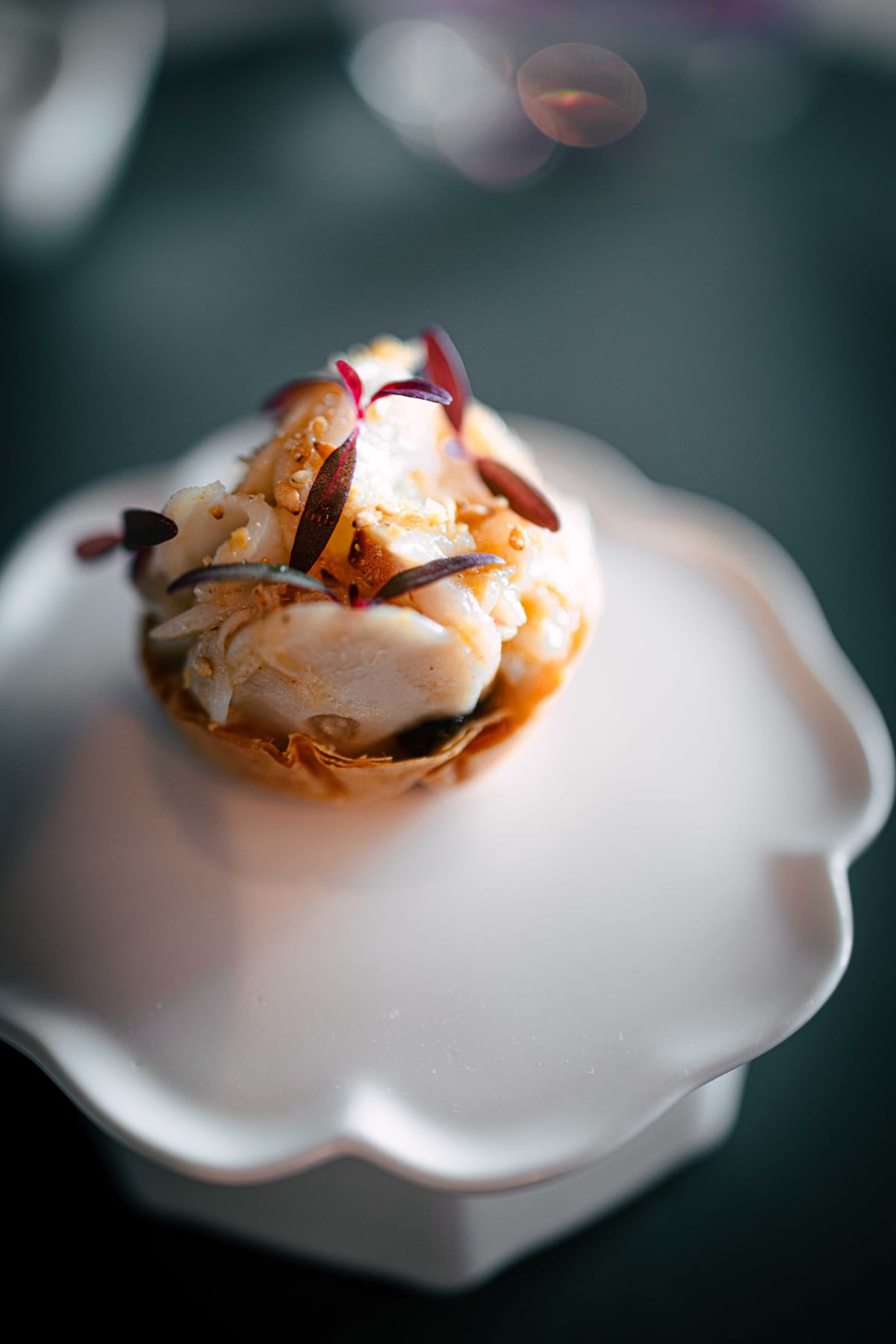 Exquisine, Seoul: the first snack, octopus in the pastry cup in close focus, with purple micro-leaves