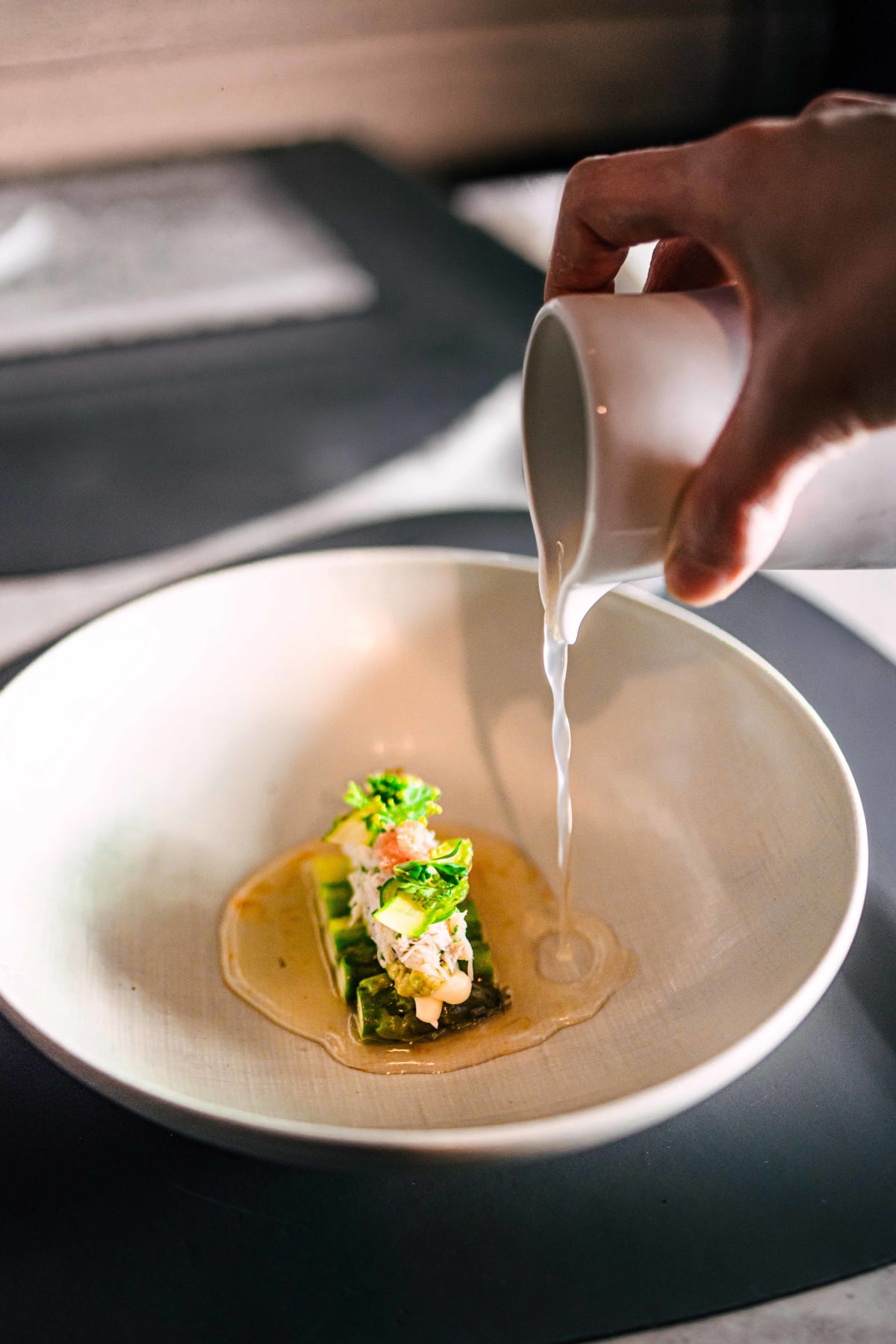 Exquisine, Seoul: the fruity sauce poured from a small white jug over the asparagus in a wide white bowl