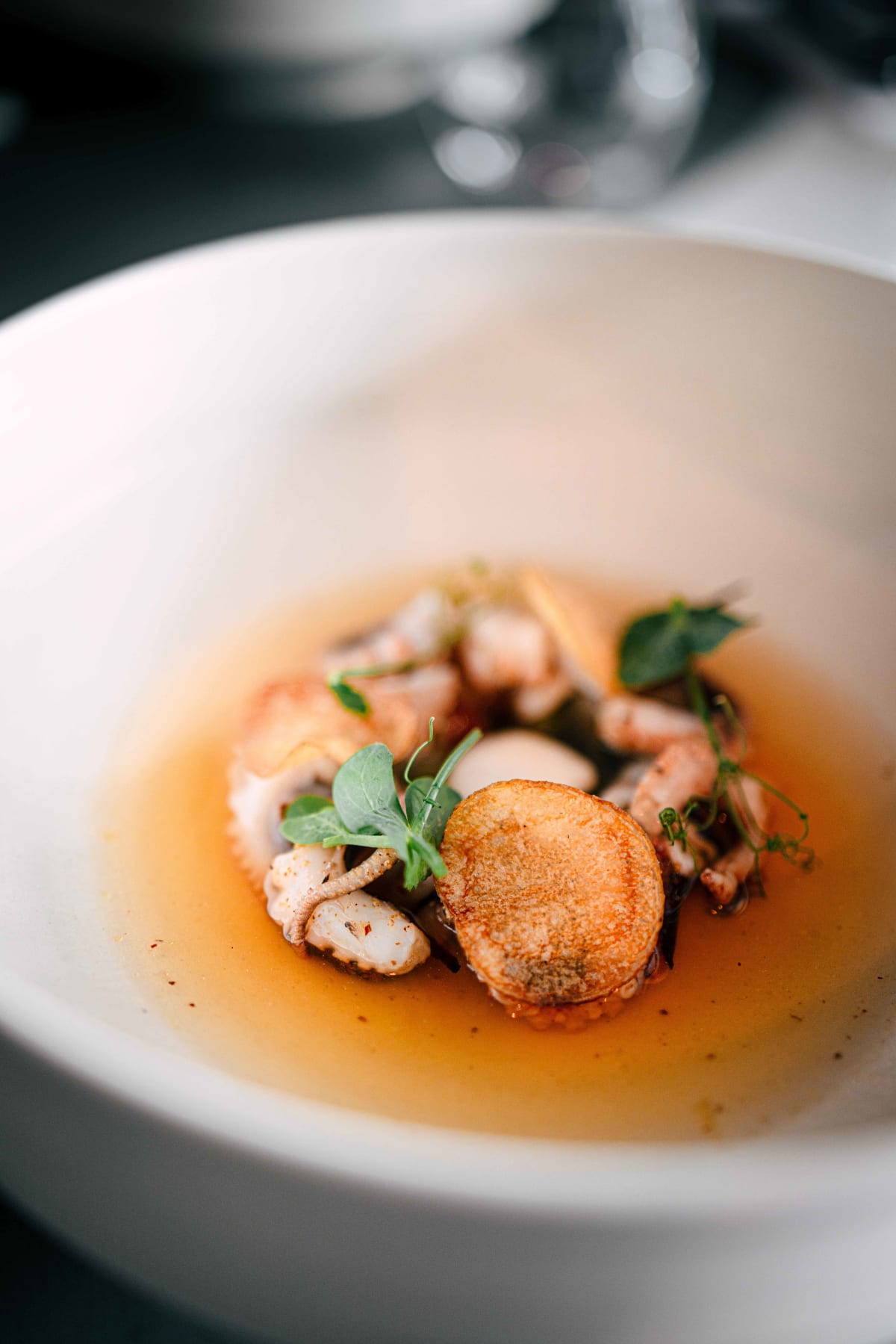 Exquisine, Seoul: the octopus and crisp potato discs in the broth up close