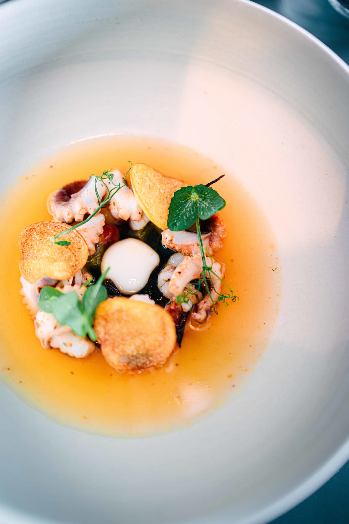 Exquisine, Seoul: the Potato course from above, octopus and potato crisps in amber broth