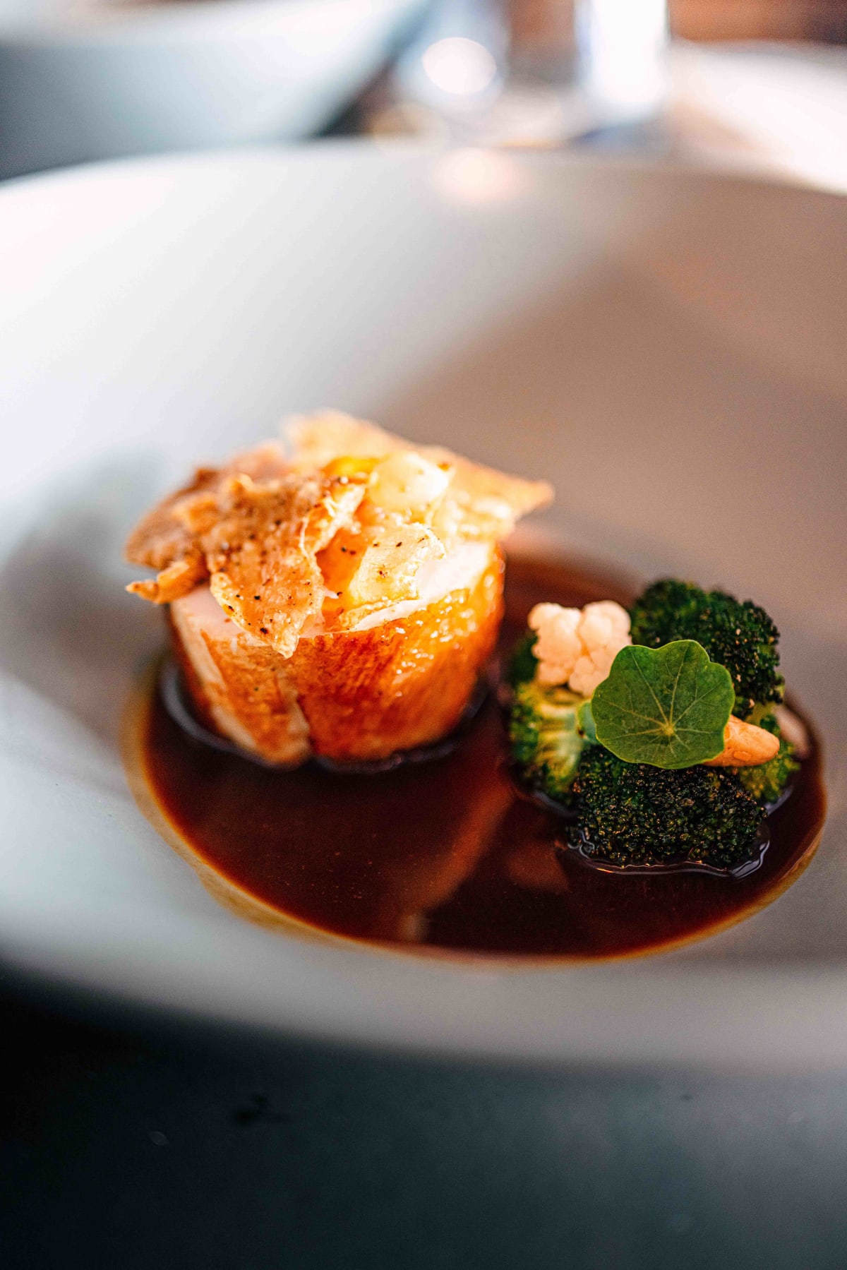 Exquisine, Seoul: the chicken up close, the crisp wafer on top and a nasturtium leaf on the broccoli