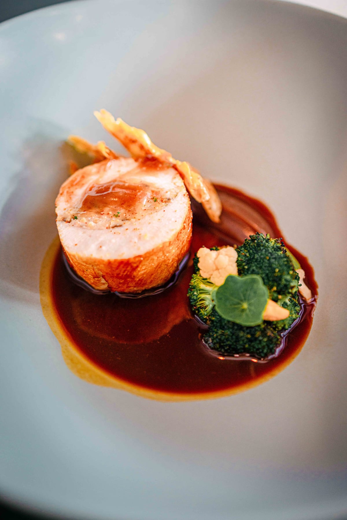 Exquisine, Seoul: the rolled chicken seen from the cut side, in its sauce