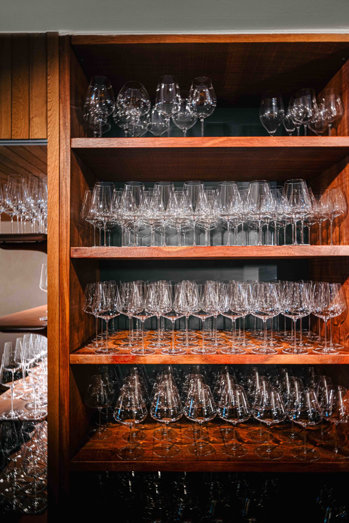Asador Etxebarri, Axpe: the glassware cabinet, and the wine cabinets topped with Domaine de la Romanée-Conti bottles