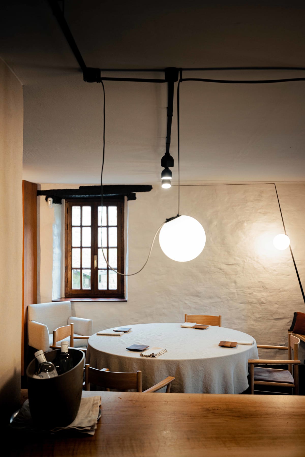 Asador Etxebarri, Axpe: a round table by the window, wine chilling beside it