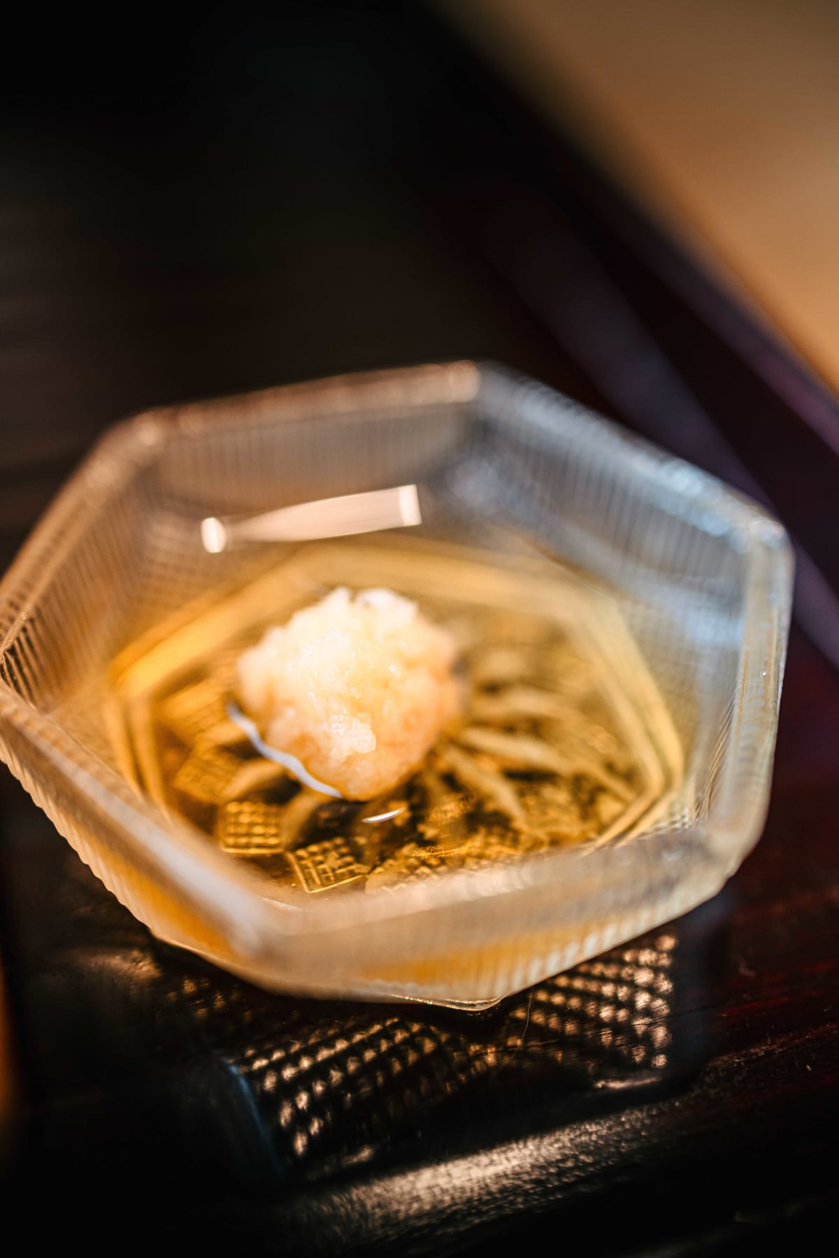 Matsukawa, Tokyo: a hexagonal glass bowl of bright, ponzu-like sauce served with the crab