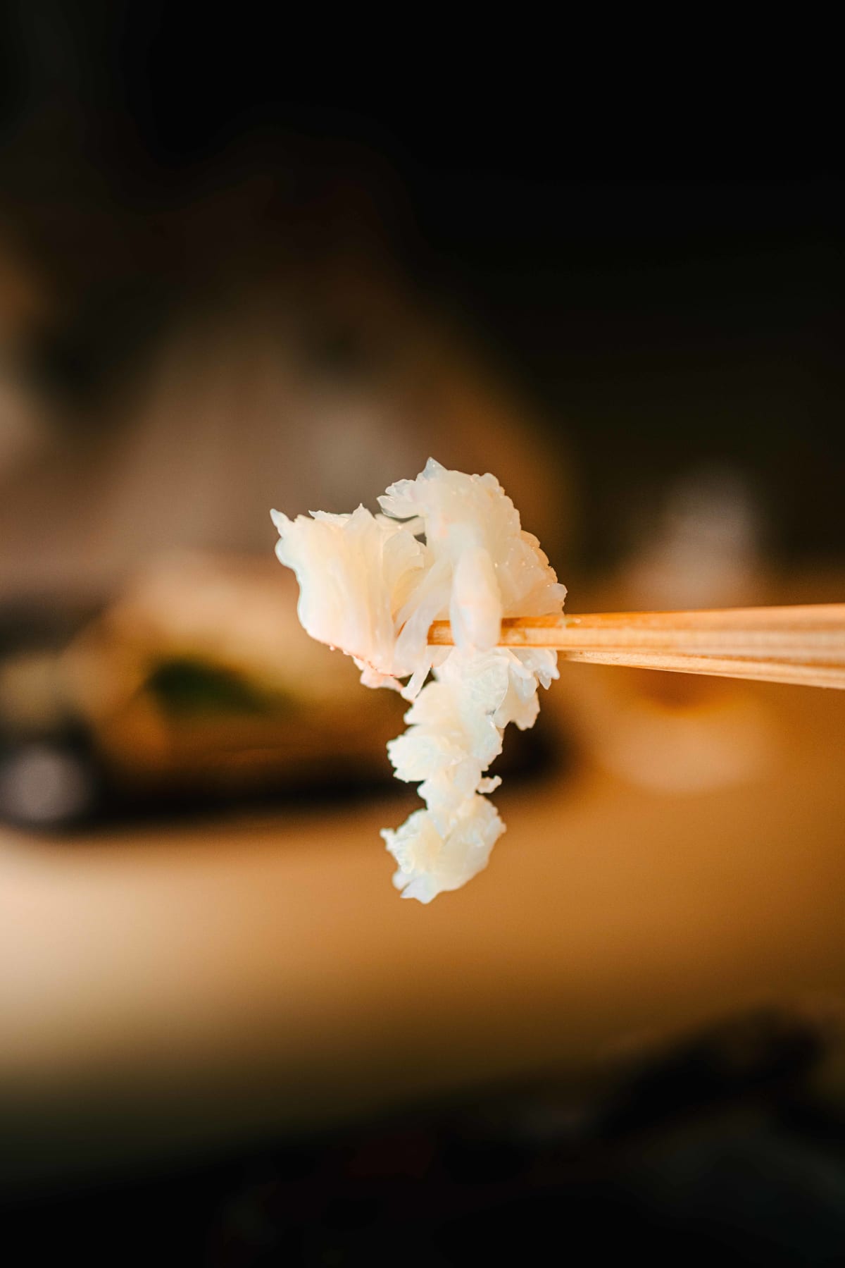 Matsukawa, Tokyo: claw meat on chopsticks, opened out into the shape of a flower