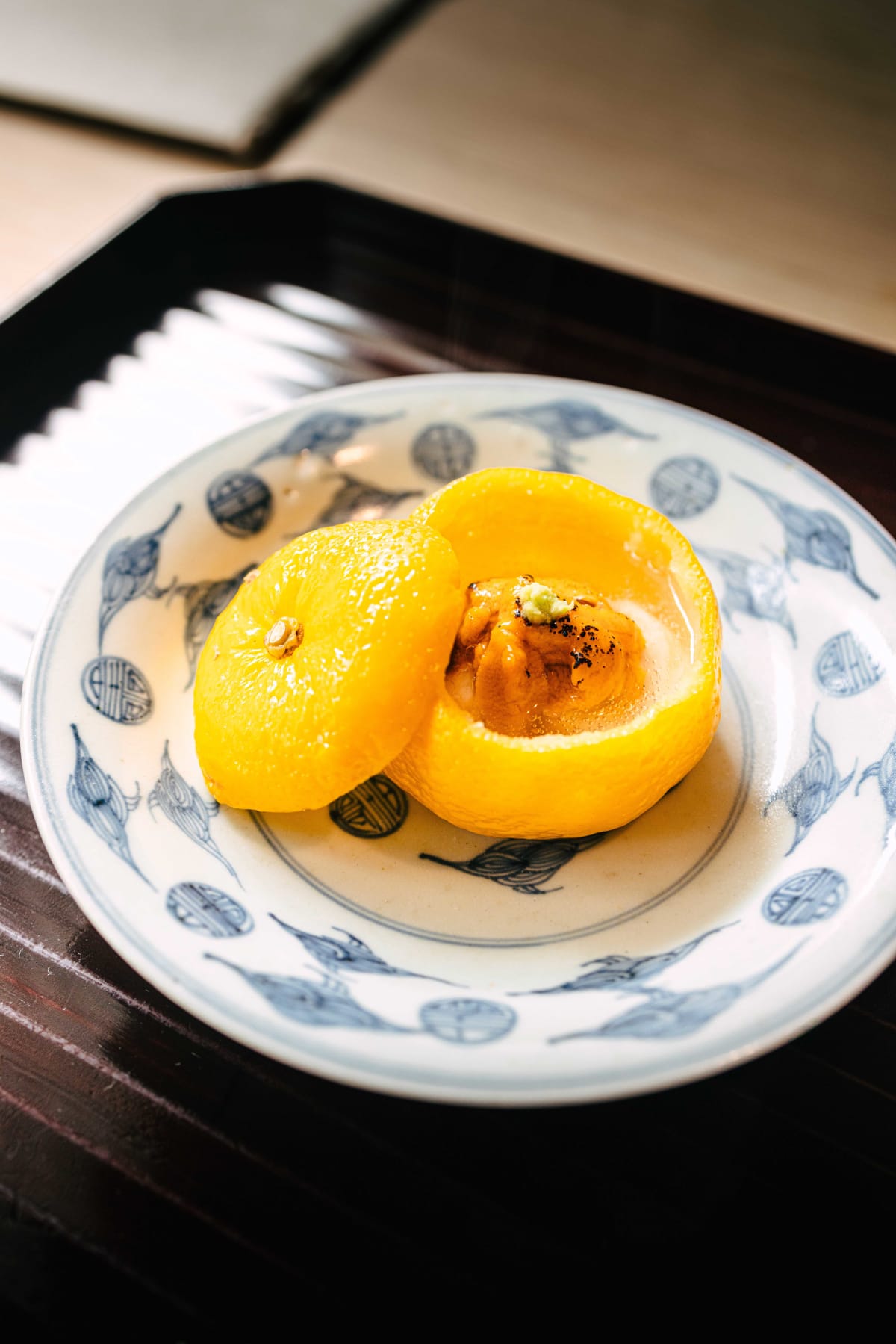 Matsukawa, Tokyo: shirako and uni inside a hollowed yuzu, its lid tipped open
