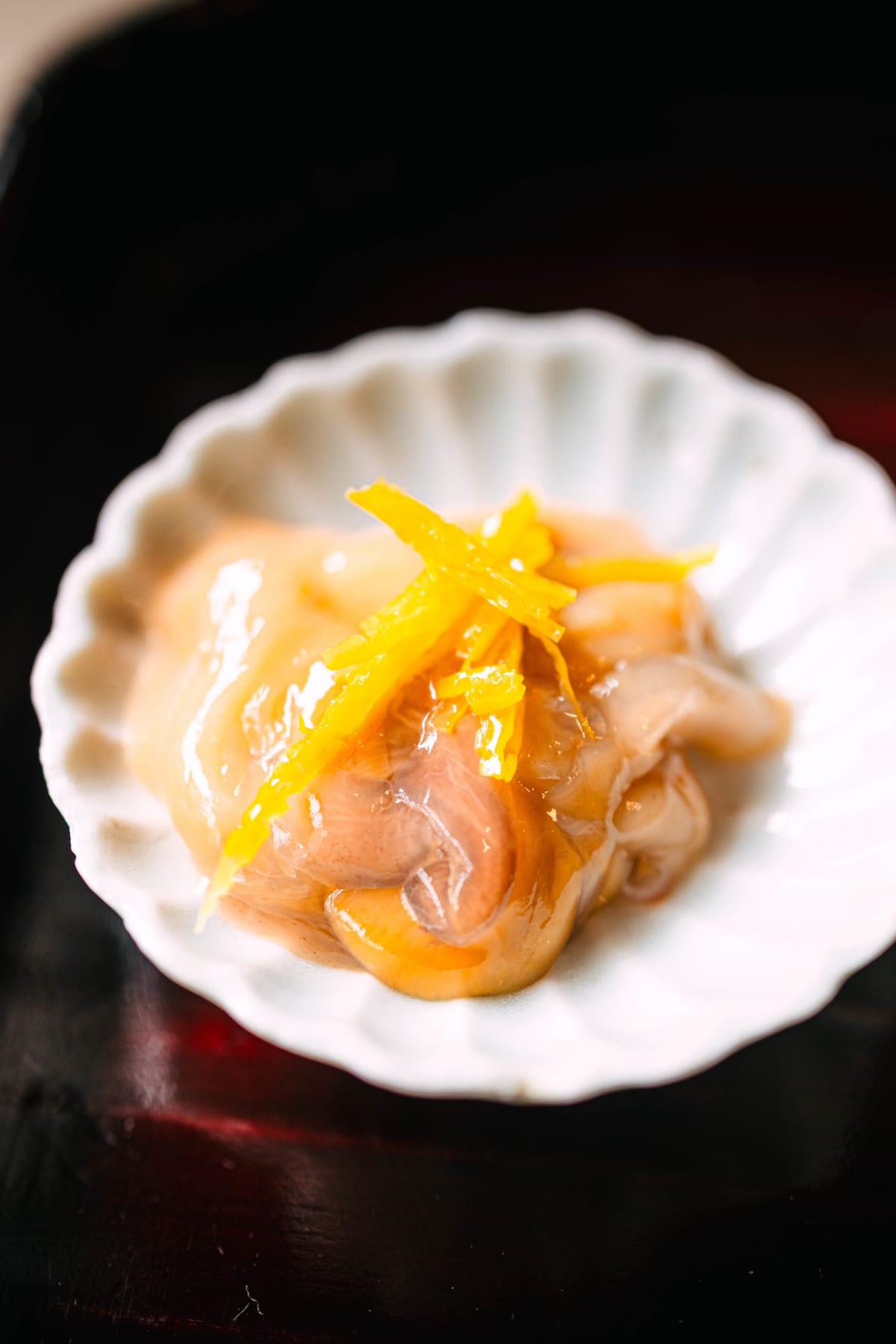 Matsukawa, Tokyo: konowata in a white chrysanthemum dish, topped with slivers of yuzu peel