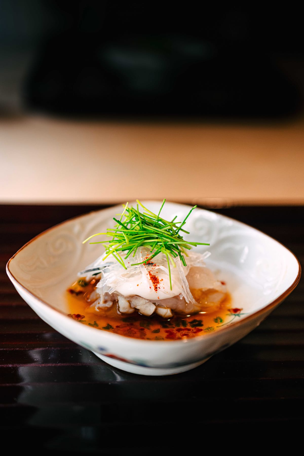 Matsukawa, Tokyo: fugu skin and flesh in ponzu and a shirako sauce, topped with chives, in an overglaze enamelled dish
