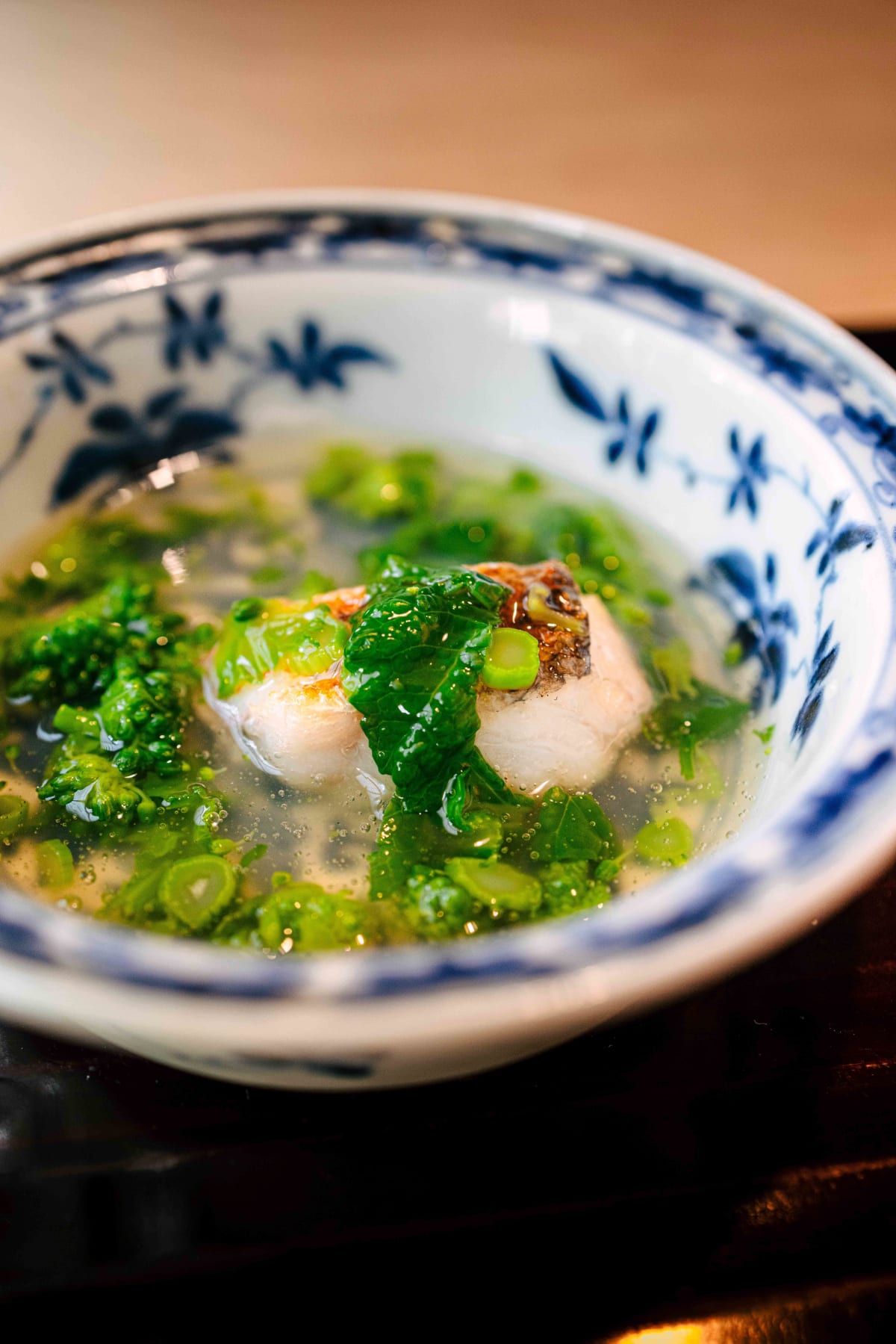 Matsukawa, Tokyo: the guji, its scales crisped, under nanohana leaves and buds