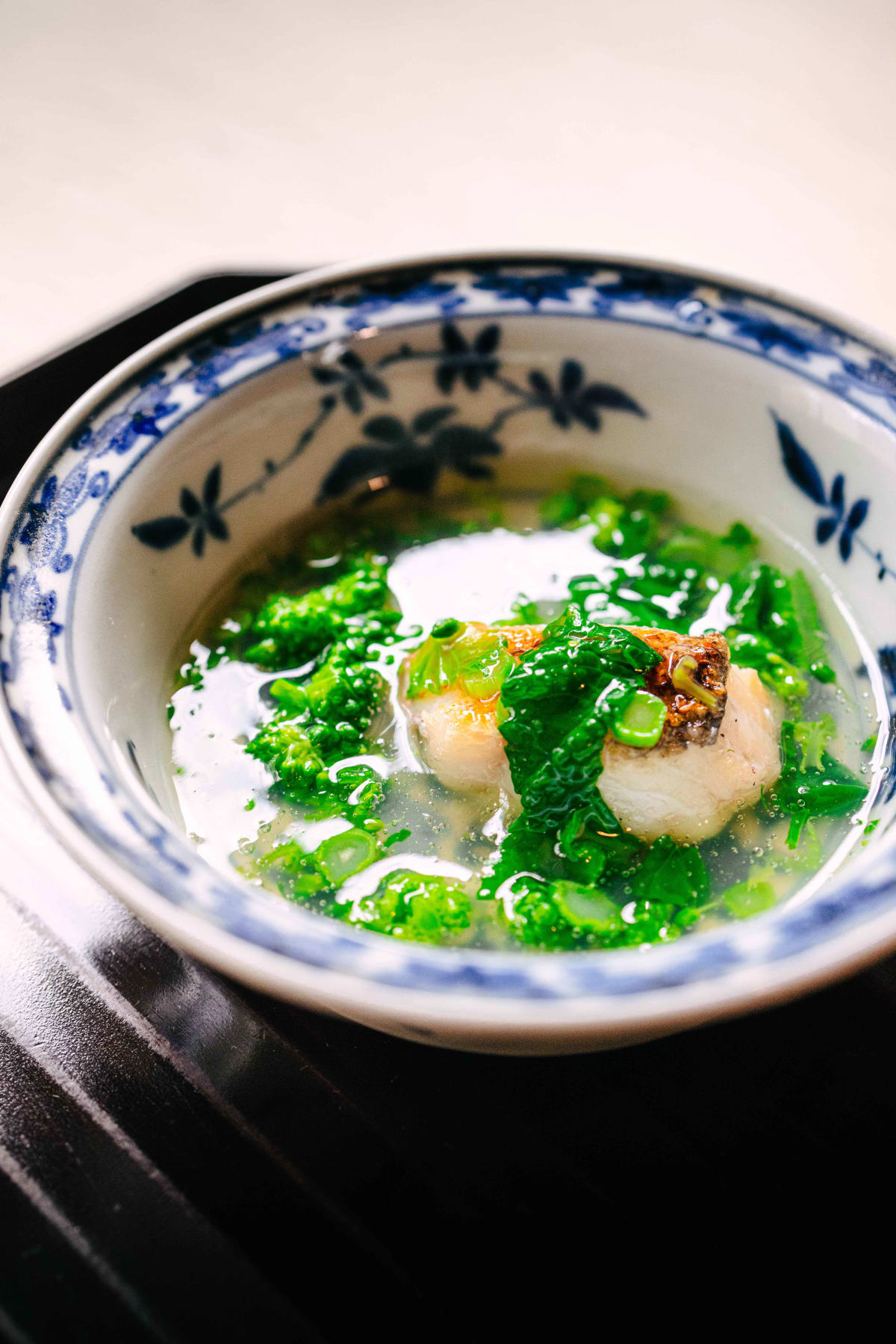 Matsukawa, Tokyo: the guji, its scales crisped, under nanohana leaves and buds