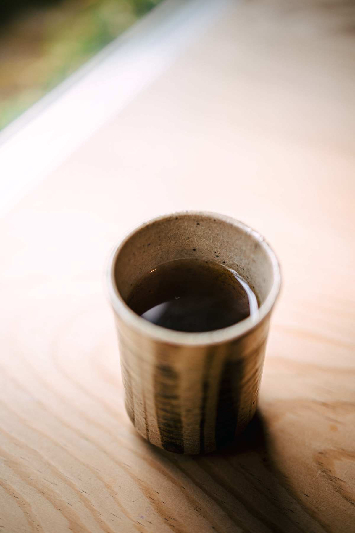 Matsukawa, Tokyo: a striped stoneware cup of dark tea, served between the soba and the rice