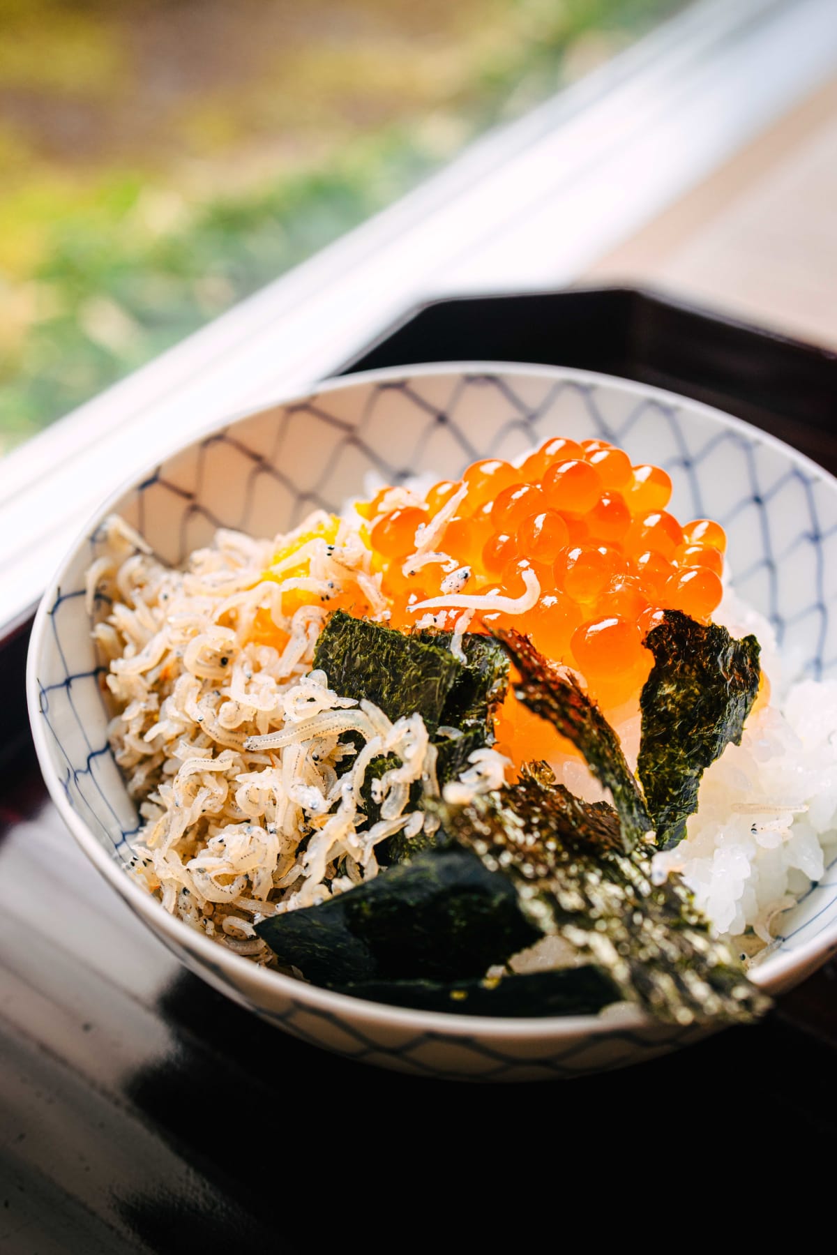 Matsukawa, Tokyo: a bowl heaped with chirimen sansho and ikura, by the window