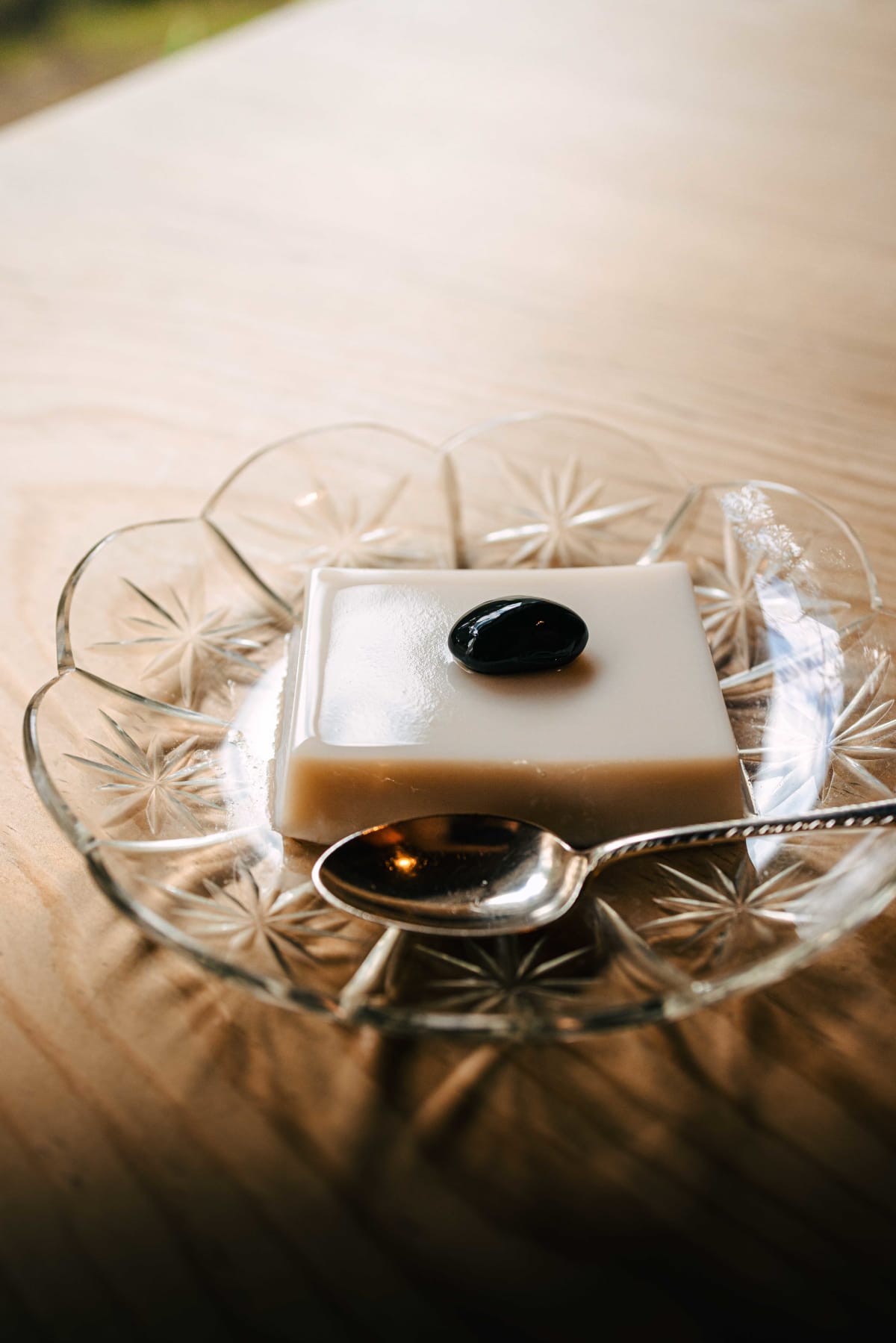 Matsukawa, Tokyo: the bean pudding topped with a single black soybean, on a cut glass plate