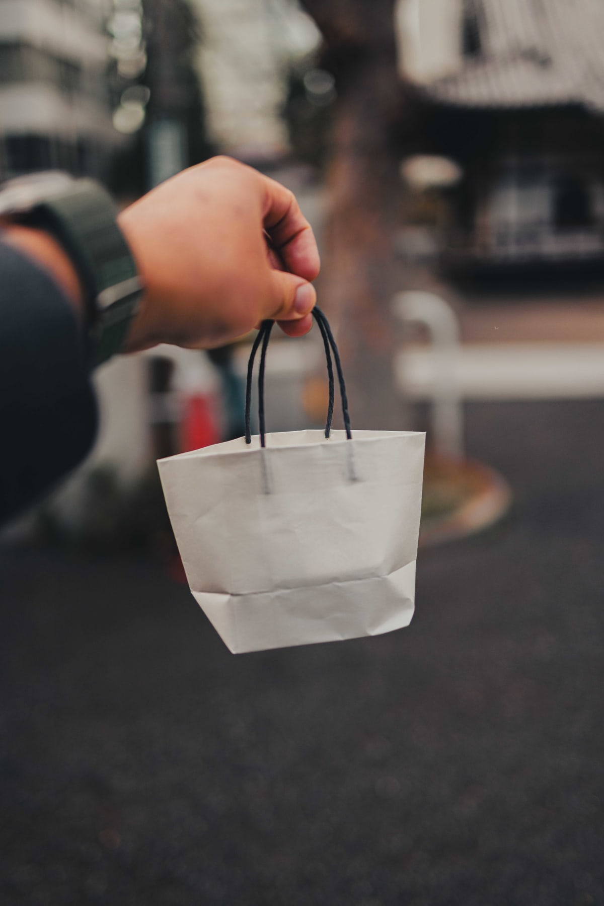 Matsukawa, Tokyo: a white paper bag in hand on the street outside the restaurant afterwards