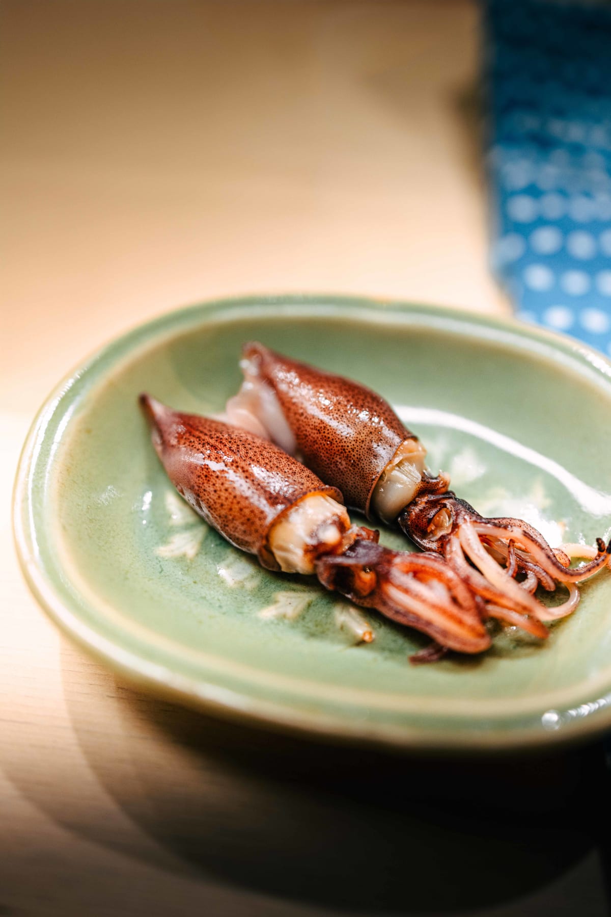 Nihonbashi Kakigaracho Sugita, Tokyo: hotaruika, two whole firefly squid on a pale celadon plate