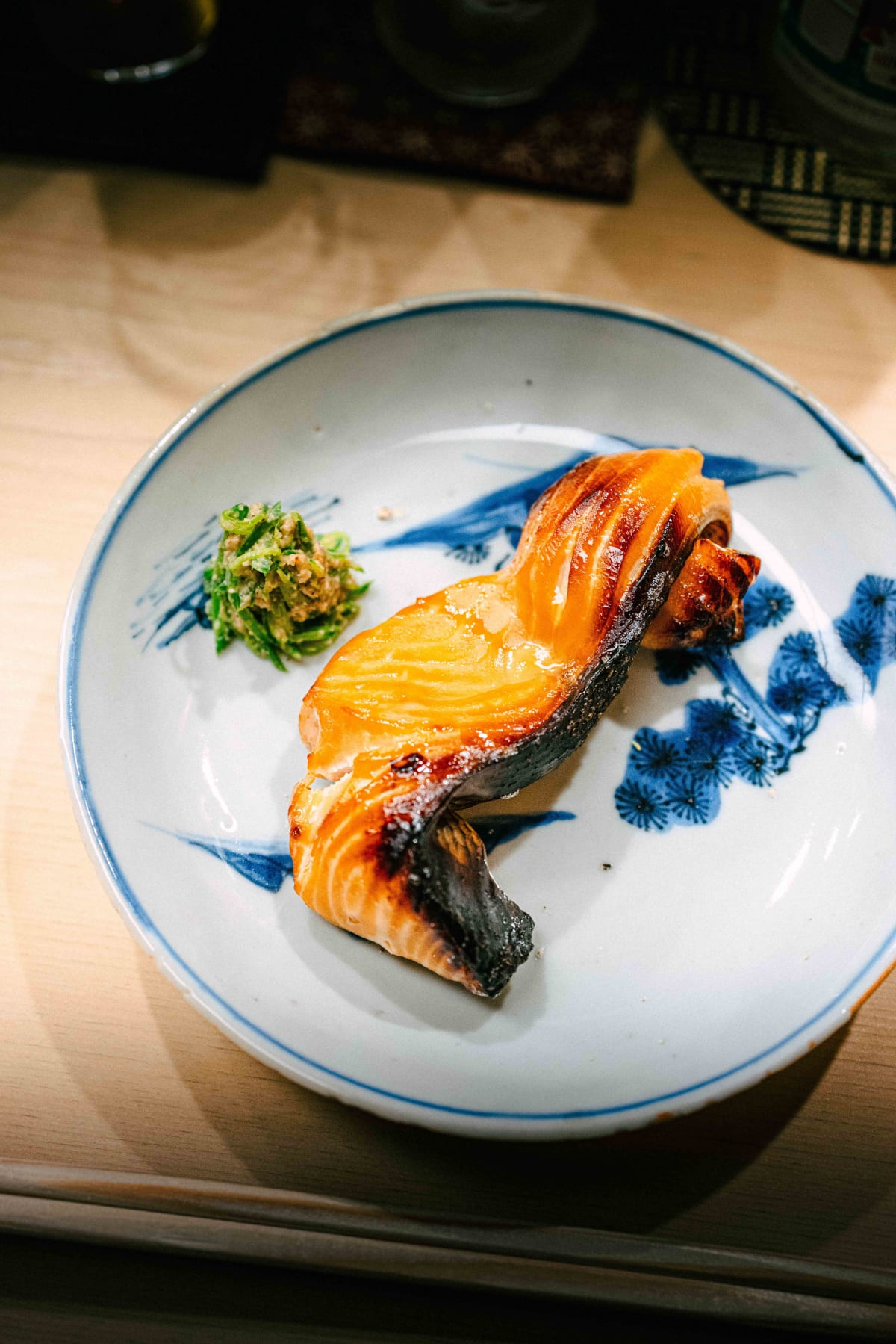 Nihonbashi Kakigaracho Sugita, Tokyo: sakura masu grilled to a glossy, browned finish, with greens dressed in sesame on a blue and white plate