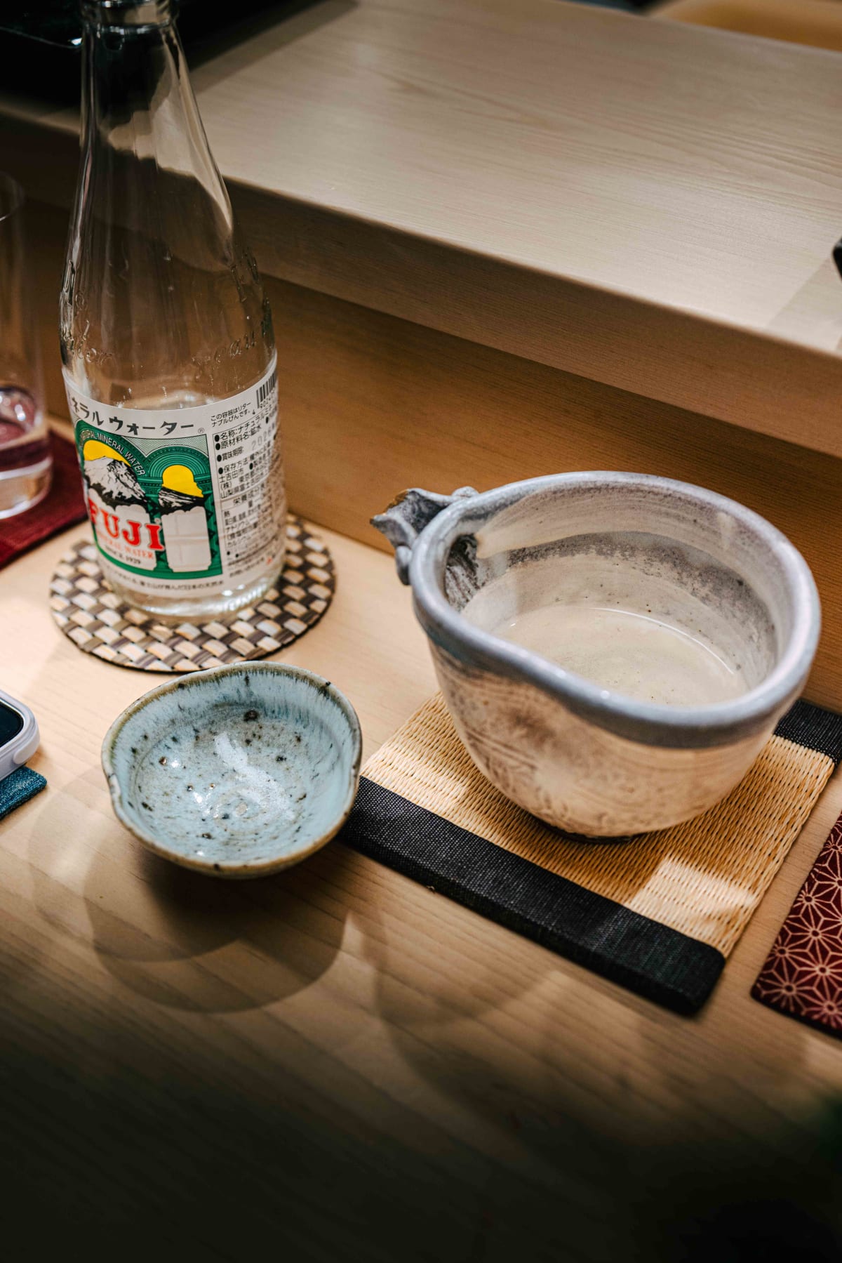Nihonbashi Kakigaracho Sugita, Tokyo: the Hoken in a rough grey stoneware katakuchi, a small speckled cup beside it