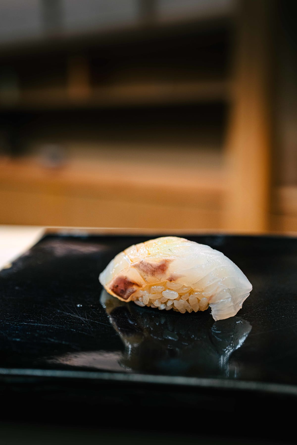 Nihonbashi Kakigaracho Sugita, Tokyo: suzuki nigiri, the translucent white flesh of Japanese sea bass with a touch of red on the skin side