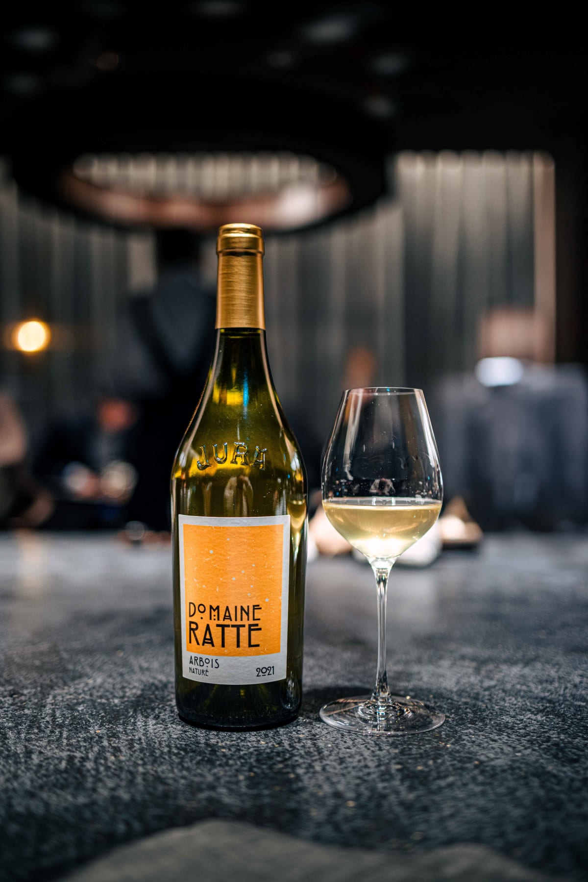 Florilège, Tokyo: Domaine Ratte Arbois Naturé 2021 in a bottle embossed with JURA, beside a poured glass