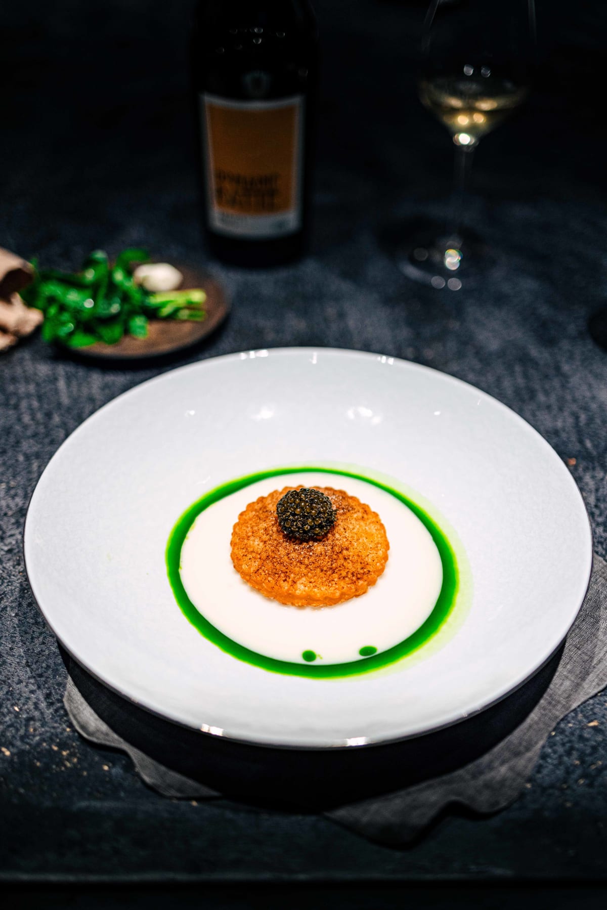 Florilège, Tokyo: the radish pie topped with tonburi and caviar, in a pool of white turnip sauce ringed with watercress oil