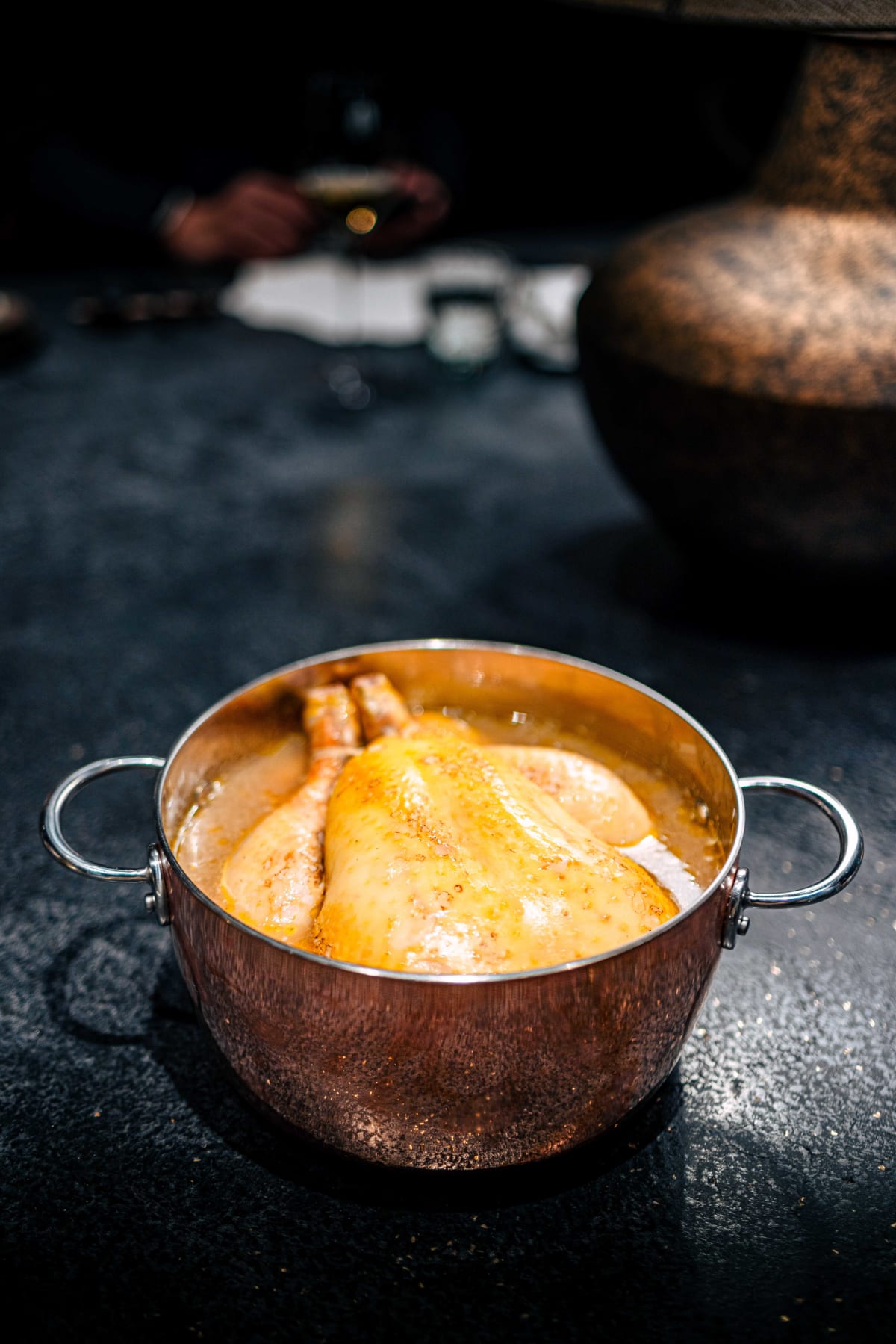 Florilège, Tokyo: the whole chicken shown in its handled copper pot, sitting in pumpkin sauce